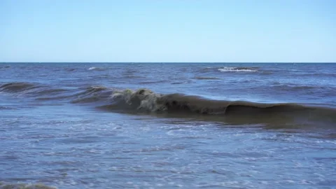 Foaming waves roll onto the sandy shore. Storm wind. Seascape. Stock Footage 135537836
