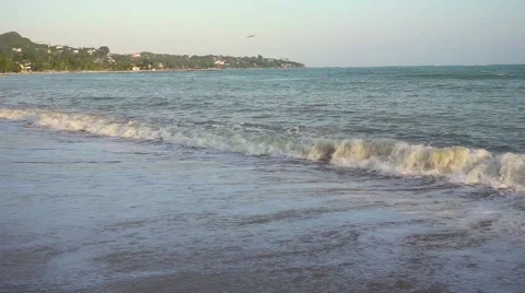 Foaming waves on sunset beach. Slow motion Stock Footage 58743199