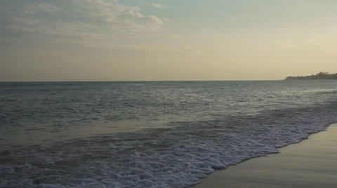 Foaming waves on sunset beach. Slow motion Stock Footage 58743264