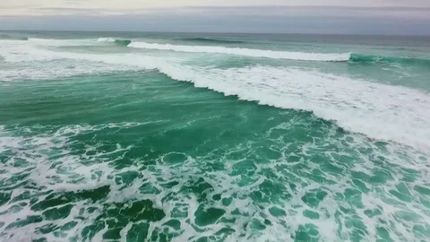 Foaming waves on the turquoise surface of the ocean next the coast of Portugal Stock Footage 76839722