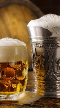 Foamy beer mugs set in rustic cellar Stock Photos