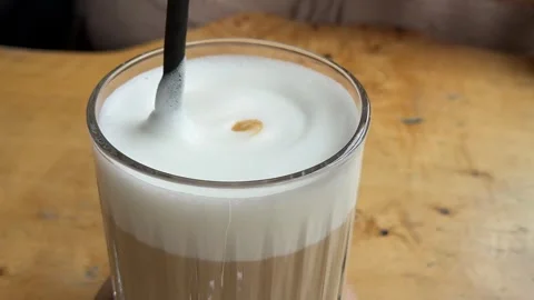 Foamy coffee drink Dalgona coffee making process. Ice milk and foamy whipped Stock Footage 324503566