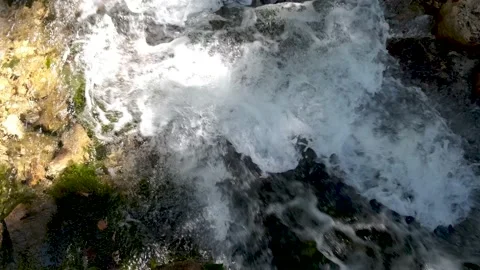Foamy mountain stream. Close-up of clear cold water flows in a rocky river. Stock Footage 141067225