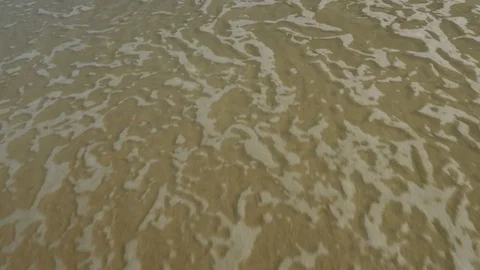 Foamy Ocean Surf Covers the Sand Video stock 76340776