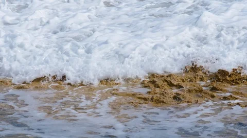 Foamy Ocean Waves Break over Rocky Shore Slow Motion Stock Footage 126066171