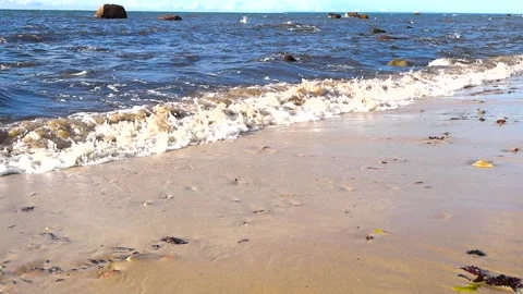 Foamy ocean waves crashing on a sandy beach shore Stock Footage 343935722