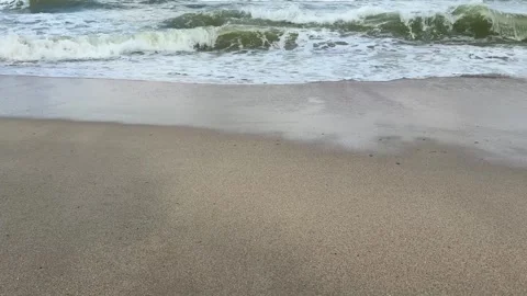 Foamy ocean waves rolling onto sandy beach Stock Footage 328336112