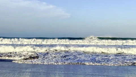Foamy ocean waves rolling onto sandy beach Stock Footage 335430693