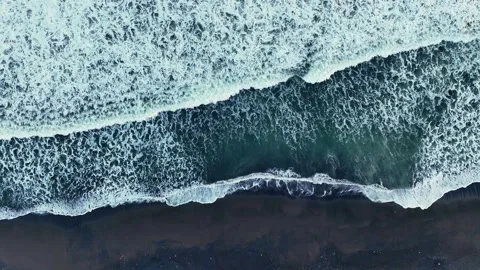 Foamy ocean waves washing onto dark sand Vídeo Stock 335440267