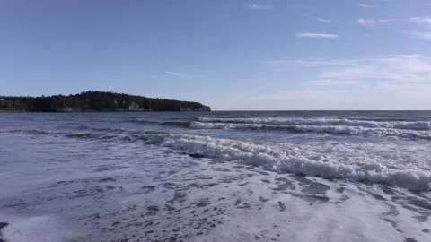 Foamy Rolling Tide under a Blue Sky Stock Footage 160772436