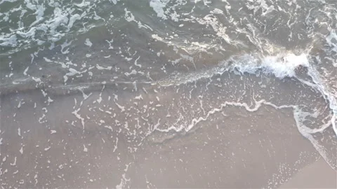 Foamy sea wave washes a sandy shore Stock Footage 117371990