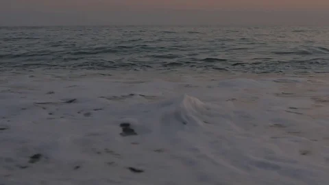 Foamy sea waves and a pebble beach Stock Footage 80245497