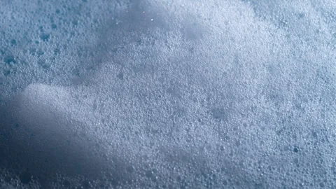 Foamy soap bubbles texture background rotates, close up Vídeo Stock 331536844