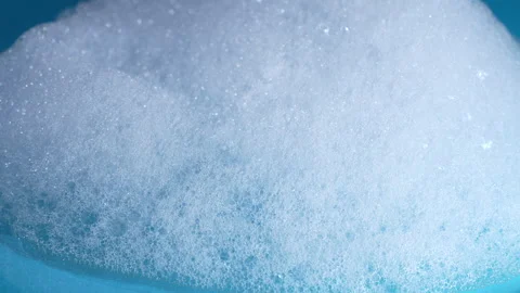 Foamy soap bubbles texture background rotates, close up Video stock 345815374