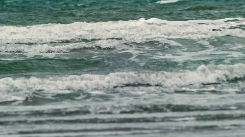 Foamy Surf Patterns Moving Across Shallow Coastal Water 動画素材 336303594