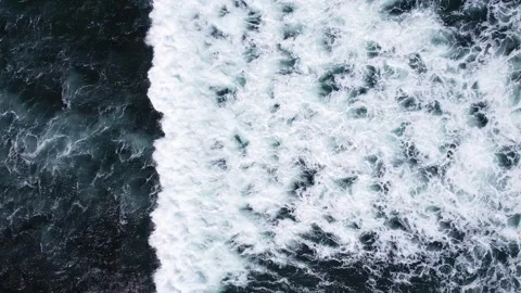 Foamy wave move over dark marble-like ocean, change it to turbulent white Stock Footage 245420078
