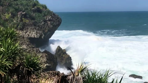 Foamy wave in the rock beach Stock Footage 147974357