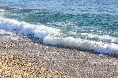 Foamy wave on a sandy beach in Turkey, sea background, April 2021 Stock Photos