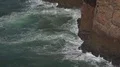 Foamy waves and sea breeze at the cliffs of Portugal coastline 4k or 4k+ Resolution
