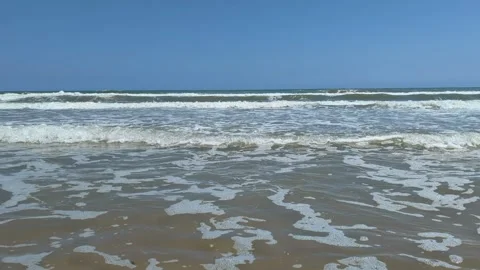 Foamy waves of Mediterranean Mareny de Barraquetes beach seashore in Valencia Stock Footage 313406982