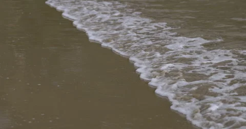 Foamy waves on the ocean shore, 4K slomo Stock Footage 246484817