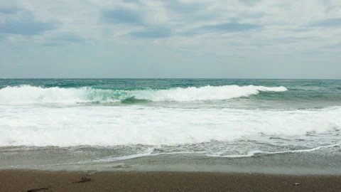 Foamy waves reaching a beach Stock Footage 220229725
