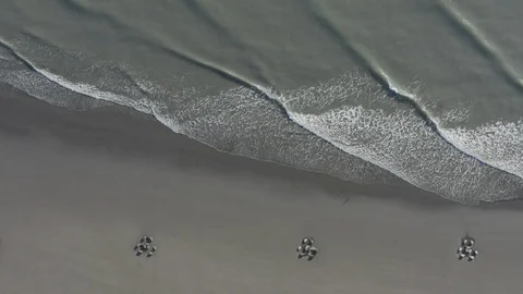 Foamy waves roll over sandy textural beach, Taichung city, Taiwan, Asia. Vídeo Stock 97586773