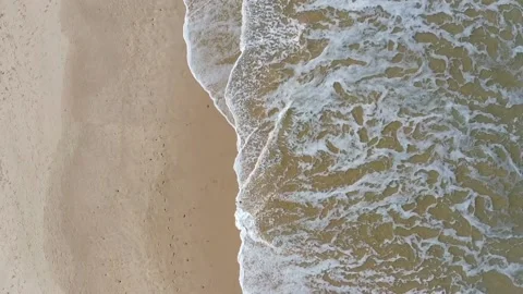 Foamy Waves Rolling Over textured Sand Stock Footage