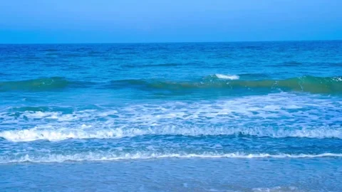 Foamy waves rolling towards the sand beach Video stock 255089937