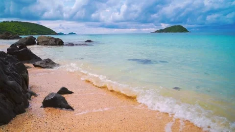 Foamy waves rolling towards the sand beach Video stock 283066413