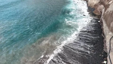 Foamy Waves Washing onto a Dark Pebble Beach Stock Footage 345576390