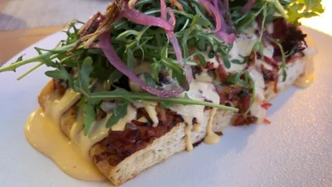 Focaccia bread topped with sliced steak and fresh salad Stock Footage 335708686