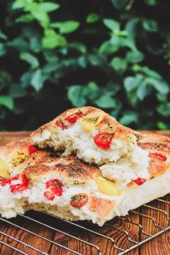 Focaccia. Italian bread. Bread with tomatoes. Homemade food. Cook at home. Stock Photos