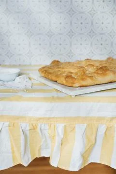 Focaccia Loaf on Marble with Patterned Wall Stock Photos