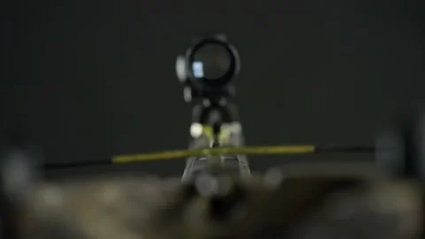Focus from the aiming device to the tip of the crossbow arrow Stock Footage 144983793