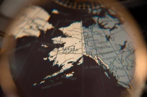 Focus on Alaska world map under magnifying glass Fotos de archivo