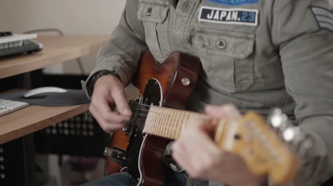 Focus in and out of man playing electric guitar Stock Footage 50243705