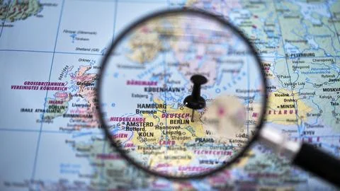 Focus on Berlin in a map with a magnifying glass Stock Photos