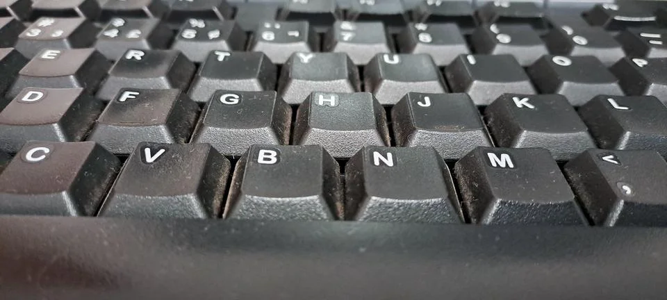 Focus on a black computer keyboard on the table. Stock Photos