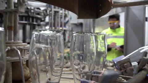 Focus at the bottle and machine . Engineer wearing protection glasses holding Stock Footage 143407868