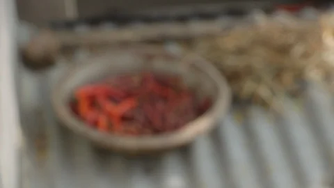Focus on a bowl of drying red chillis on a roof top in rural India. Stock Footage 95548893