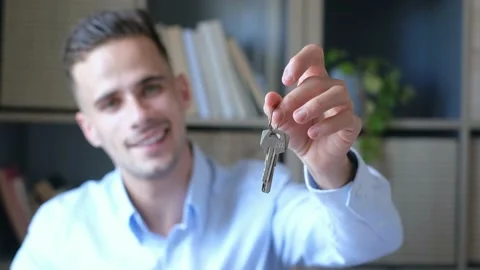 Focus on bunch of keys from house flat apartment in hand of smiling male. Blurre Stock Footage 171902083