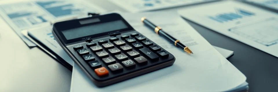 Focus calculator button with blur data analysis paper and pen. Insight Stock Photos