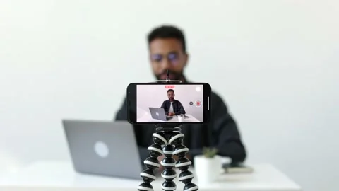 Focus camera phone good-looking african-american in glasses recording video 4k Stock Footage 196126986