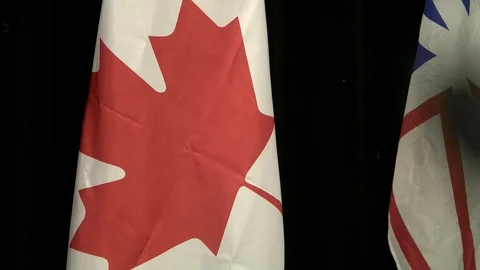 Focus from canadian flag to microphone tip close up Stockbeeldmateriaal 88257500