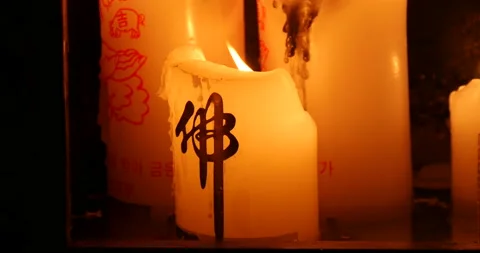Focus of candle light with mark of buddhism Stockbeeldmateriaal 162616397