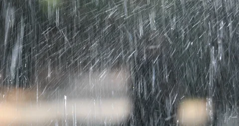 Focus change from the droplets splashing onto the path in the park Stock Footage 119047114