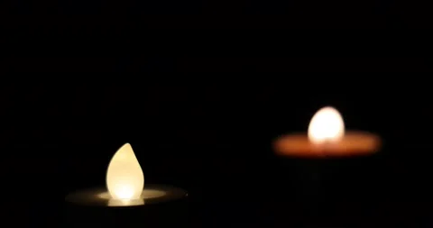 Focus change on LED light and wax candle flame light glowing jumping throbbin Stock Footage 172425377