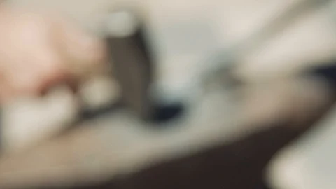 Focus changing. Blacksmith manufactures sheet metal plant. Hammer. Forge. Clo 動画素材 111265605