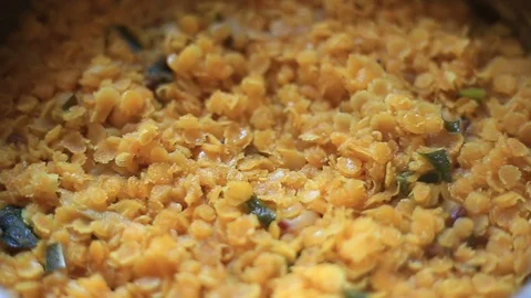 Focus changing blurry rotating close up of cooked hot smoking dhal curry Video stock 129480417